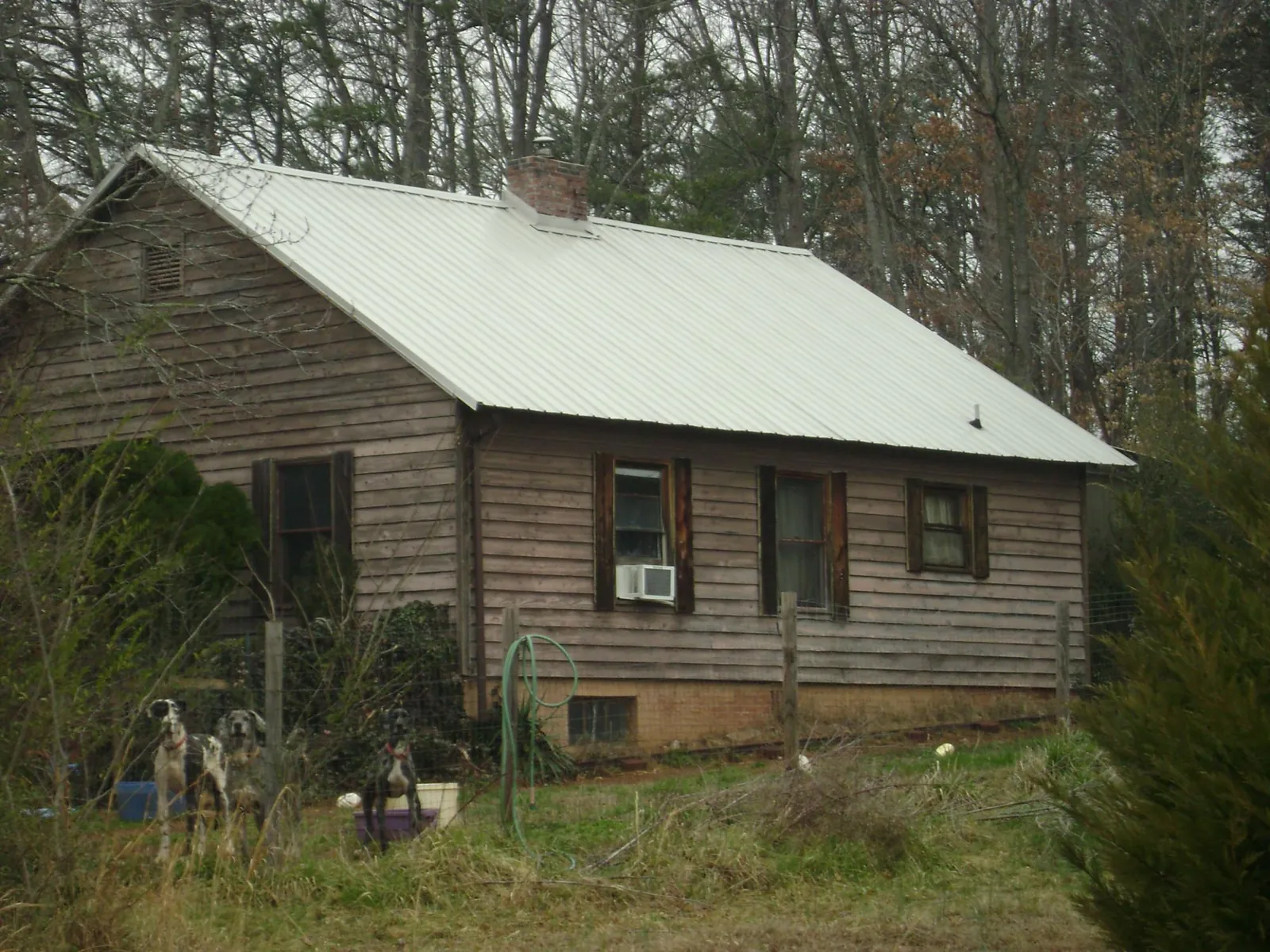 White metal roof on an old wood sided farmhouse, from a Metal Roof Installation job in Stirum
